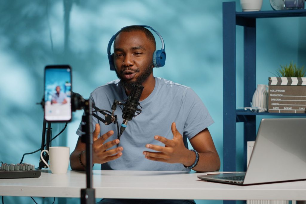 Stock Images man in recording studio recording podcast for social media marketing