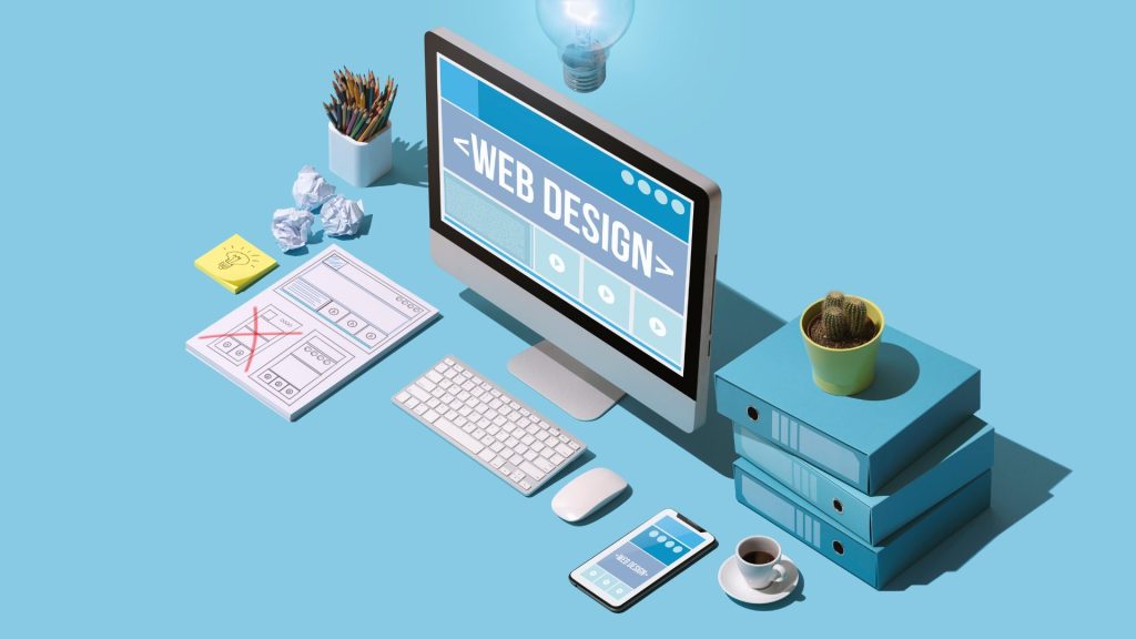 a computer with the words "web design" on the screen with papers all around it and a blue background